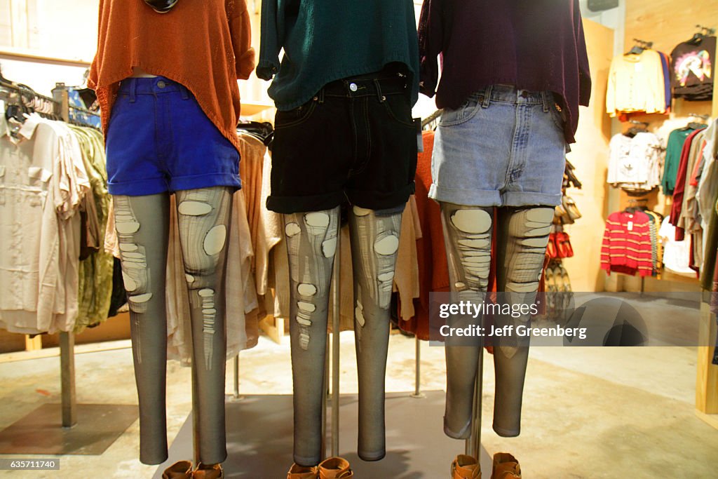 Ripped leg stockings on mannequins in Urban Outfitters.