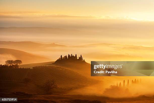 sunrise with rays over the misty valleys in tuscany,italy. - italy landscape stock pictures, royalty-free photos & images