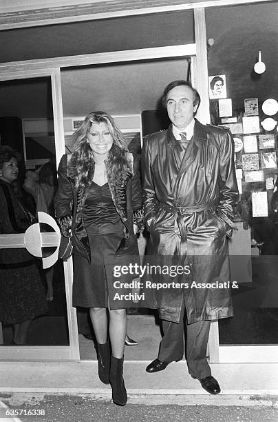 Italian actress and singer Alida Chelli and Italian TV host Pippo Baudo getting out from a club. Rome , 1976