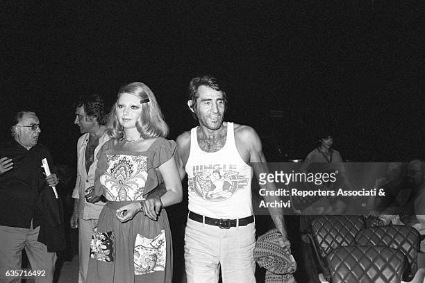 The Italian actor, comician and host Walter Chiari walking arm in arm with the actress Sylva Koscina inside a theatre during rehearsal of a show....