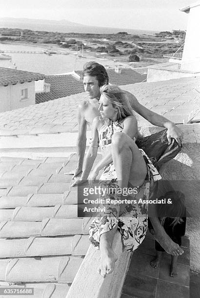 Italian actor, comedian and TV host Walter Chiari on vacation in his Sardinian villa watching the panorama with his wife, Italian actress and singer...