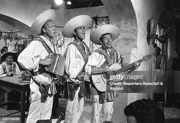 Italian actor and comedian Walter Chiari , in the middle, with Italian actors Ugo Tognazzi and Raimondo Vianello , dressed as mariachi, in a scene...