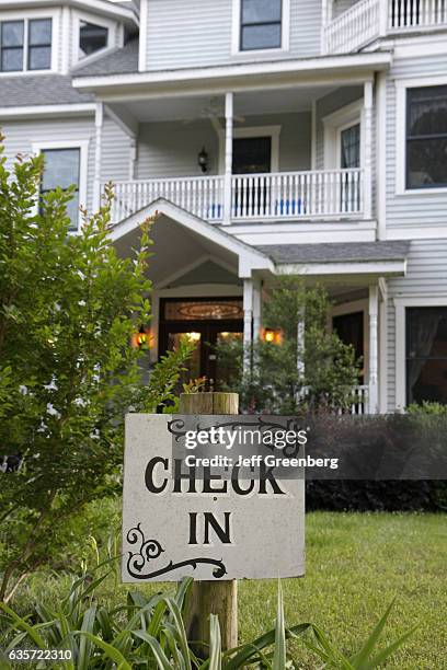 Check-in sign outside Country Oaks Bed and Breakfast.