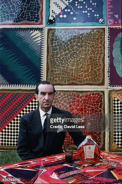 The Florentine designer Emilio Pucci, pictured with an array of his creations in the form of colorful table tops, Florence, Italy, 1959.