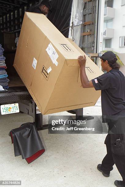 Delivery men delivering a recliner chair.