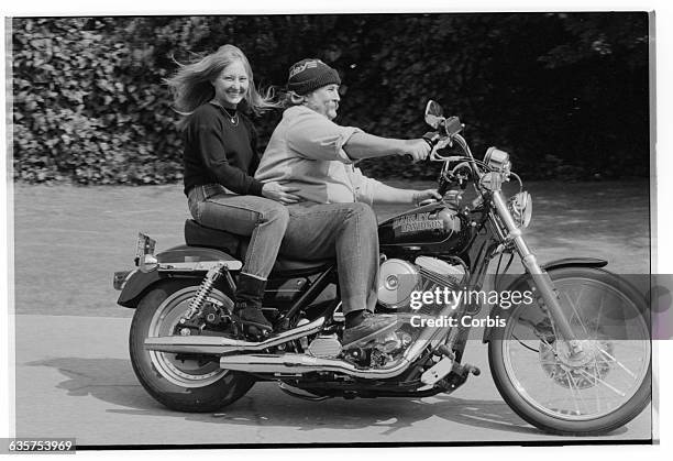 Jan Dance rides behinds her fiancee, David Crosby, in the driveway of their home. Crosby was a member of the 1960s band, the Byrds, and then helped...