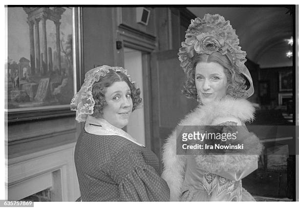 Enid Hartle and Jane Turner pose for a photographer in their costumes for the opera La Traviata. Hartle performs as Annina, Violetta's maid. Turner...