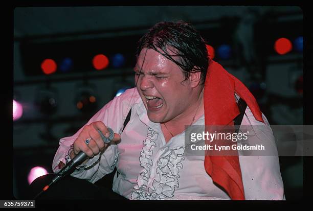 Meat Loaf sweats profusely as he sings on stage.