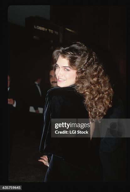 Actress Brooke Shields in a formal Black Velvet dress peeks around her shoulder outside in this circa 1985 color slide.