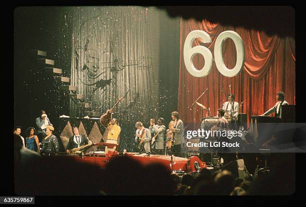 Rock and roll legend Chuck Berry receives a red convertible at his 60th Birthday Concert. Among the performers on stage with Berry are Etta James and...