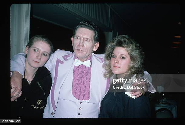 Rock and roll legend Jerry Lee Lewis embraces his wife Kerrie Lynn and daughter Pheobe.