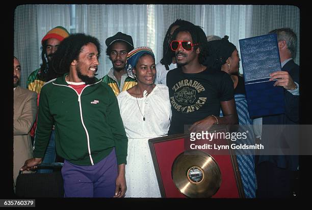 Bob Marley and Bunny Wailer receive a gold record for sales with their band the Wailers.