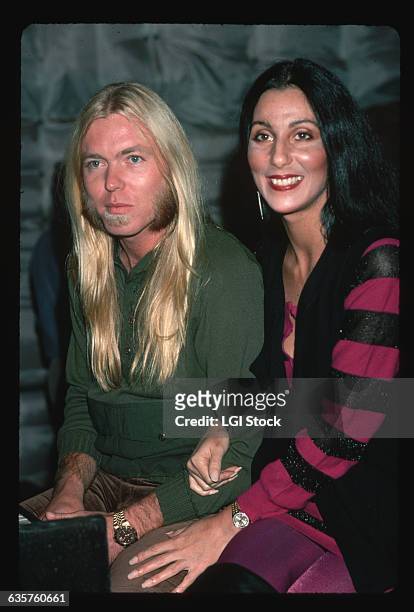 Cher holds onto the arm of husband Gregg Allman, singer and keyboardist for the Allman Brothers.