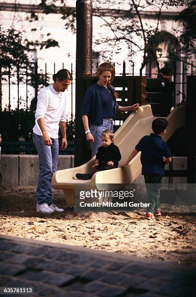Nicole Kidman and Tom Cruise play with their daughter, Isabella Jane, on a slide in Central Park.