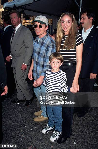 New York, New York: Picture shows actor, Michael J. Fox, holding hands with his wife, Tracy Pollan, and his son, Sam, at the Kids for Kids benefit.