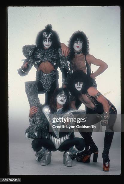 Full length, studio portrait of the theatrical, American rock & roll band Kiss. Clockwise from upper left: bassist and singe Gene Simmons, guitarist...