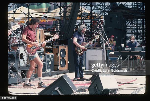 Guitarists Jerry Garcia and Bob Weir play with the Grateful Dead in concert.