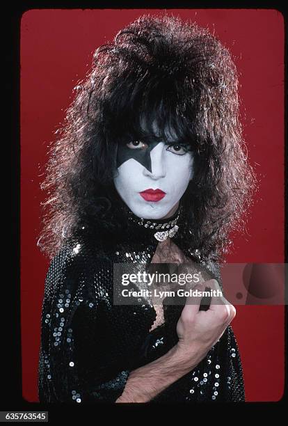 Paul Stanley, lead singer and guitarist with the rock and roll group KISS, is shown in a studio portrait. He is wearing make-up and a costume.