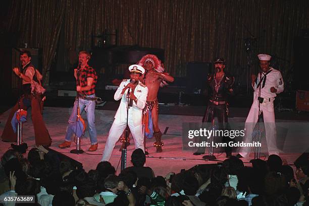 The Village People on stage performing. All members are visible in this general view of the stage. Photograph, 1979.