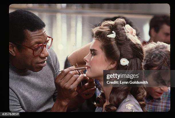 Makeup artist applies makeup to actress Brooke Shields before the filming of a television commercial for Wella Balsam shampoo.