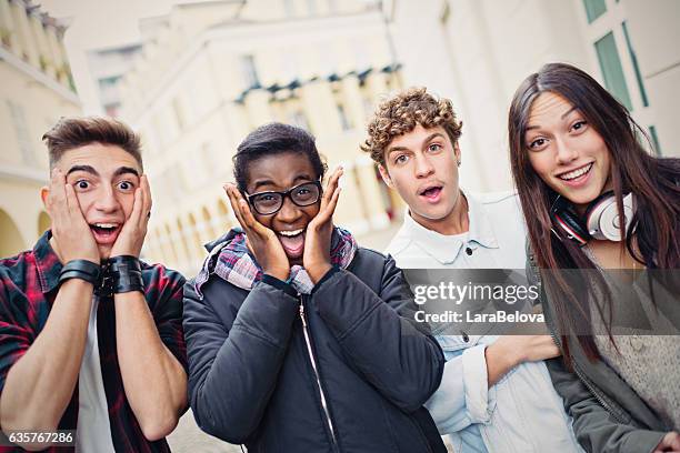 mixed race surprised group of students - teen disbelief stock pictures, royalty-free photos & images