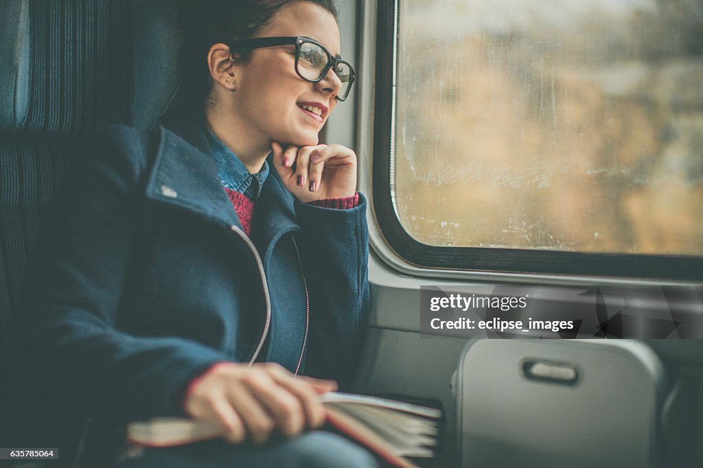 Girl Riding a Commuter Rail Train