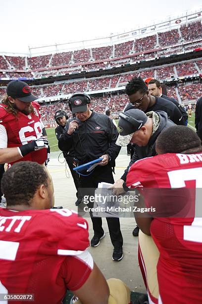 Head Coach Chip Kelly of the San Francisco 49ers talks with the offensive line on the sideline during the game against the New York Jets at Levi...