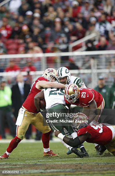 Nick Bellore, Jaquiski Tartt and Glenn Dorsey of the San Francisco 49ers tackle Bilal Powell of the New York Jets during the game at Levi Stadium on...