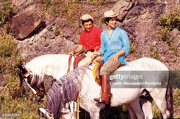 Music lyricist Mogol and singer Lucio Battisti riding horses around Rome. Rome , 1960s