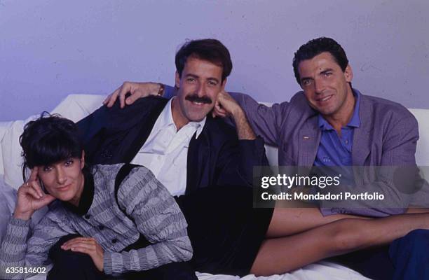 The comic trio formed by Massimo Lopez, Anna Marchesini and Tullio Solenghi posing sitting on the theatre chairs for the theatre show 'Allacciare le...
