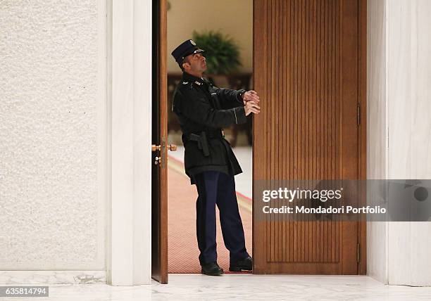 Security guard opening the door of the Paul VI Audience Hall. Pope Francis is going to begin the general audience - a shared moment of meditation for...