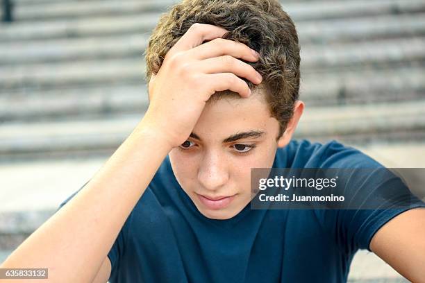 portrait of a posing pensive male teenager - turkse etniciteit stockfoto's en -beelden