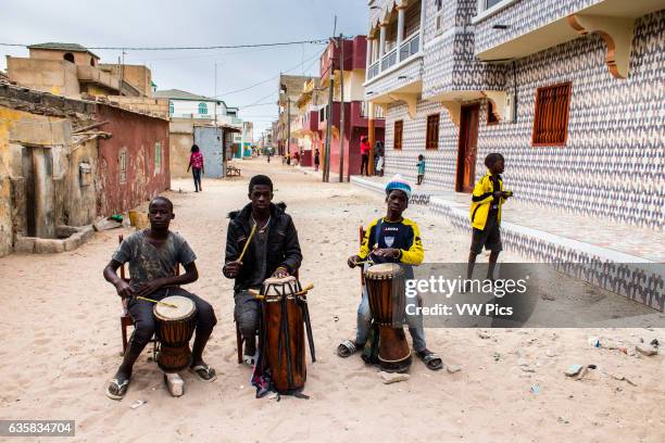 Boys playing drums on the streets of Saint-Louis.