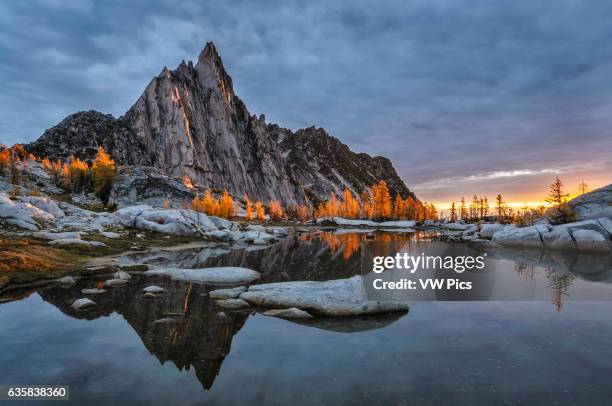 Prusik Peak, Gnome Tarn and alpine larch trees at sunrise; The Enchantments, Alpine Lakes Wilderness, Washington.