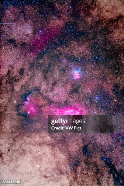 The spectacular field of Messier 8 and 20 emission and reflection nebulas in Sagittarius, with M8, aka the Lagoon Nebula below, and M20, the Trifid...