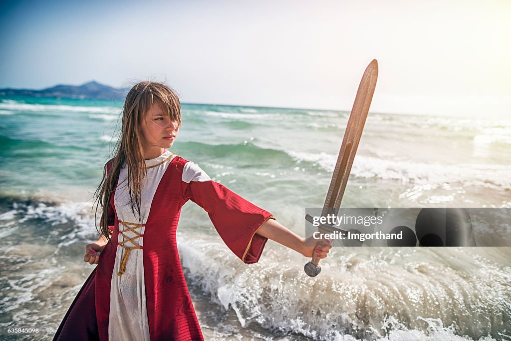 Young viking shieldmaiden practicing with sword