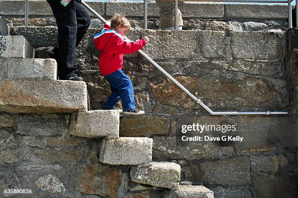 boy walking down steps - dun laoghaire stock-fotos und bilder