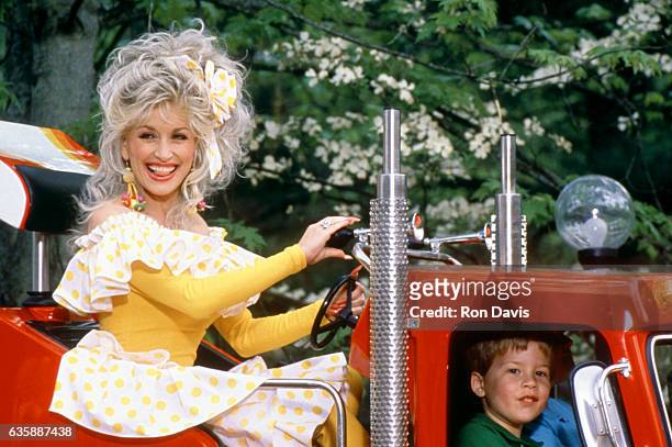 American singer and songwriter Dolly Parton rides on a truck at her Dollywood theme park circa 1997 in Pigeon Forge, Tennessee.