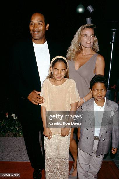 Simpson and Nicole Brown Simpson walk the red carpet with their children Sydney and Justin as they attend the "Naked Gun 33 1/3: The Final Insult"...