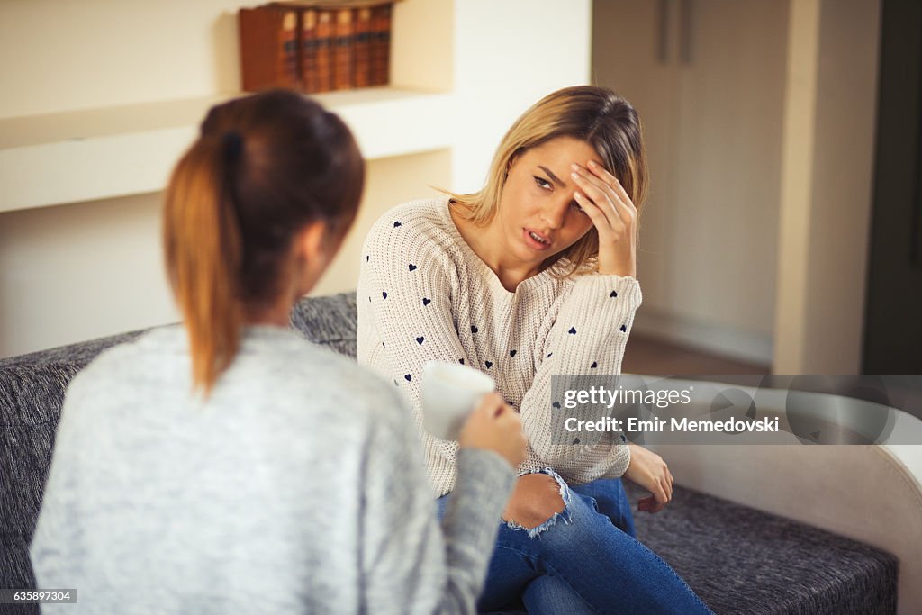 Young woman comforting her friend after bad break up