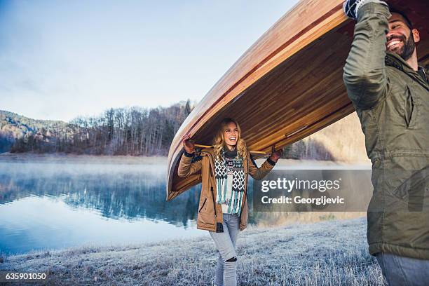 carrying a canoe - two people canoeing on a lake stock pictures, royalty-free photos & images