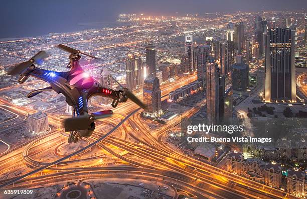 drone flying over a futuristic city - drone images stock pictures, royalty-free photos & images