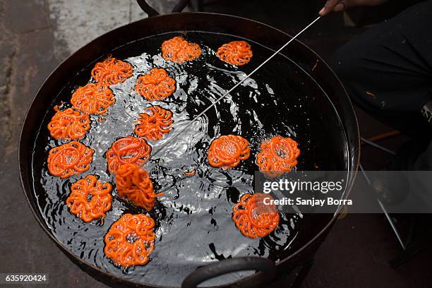 close up of colorful indian sweet jalebi made with flour and sugar syrup - mithai stock pictures, royalty-free photos & images