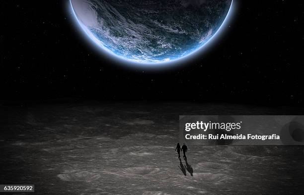 couple walking in the moon watching the planet earth - world war 2 stock-fotos und bilder