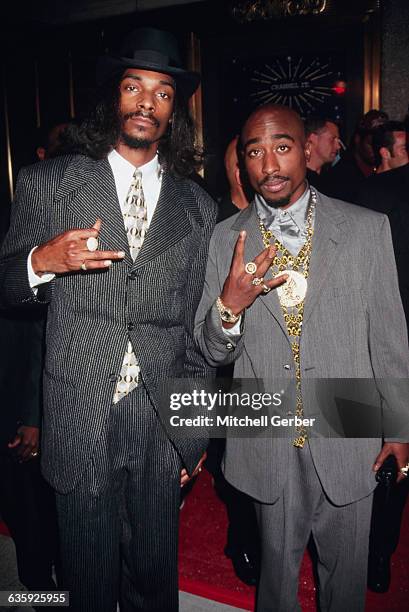 Rappers Snoop Doggy Dogg and Tupac Shakur flash gang signs while attending the 1996 MTV Video Music Awards at Radio City Music Hall.