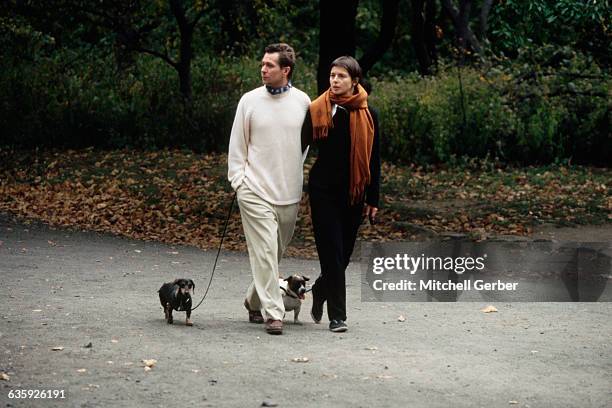 Gary Oldman and Isabella Rossellini walk their dogs in the park and share a quiet moment together as a couple.
