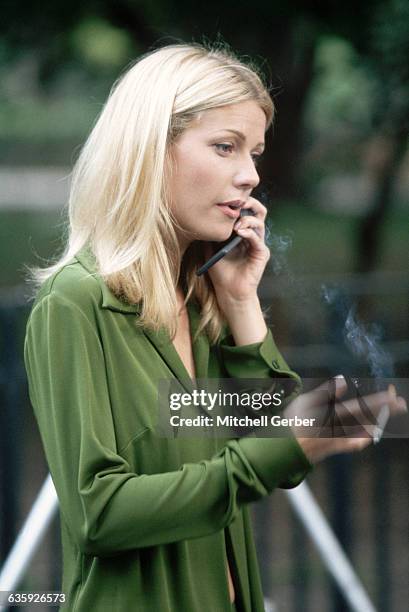 Gwyneth Paltrow smokes a cigarette and talks on her cellular phone during a work break. She works on filming the motion picture Great Expectations.