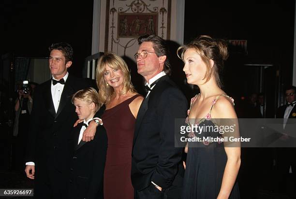 Kurt Russell and Goldie Hawn in the lobby of the Waldorf-Astoria Hotel with their son Wyatt. They are flanked by Goldie's children, Oliver and Kate...