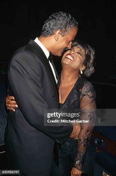 Author, businessman, and ex-athlete Stedman Graham hugs his girlfriend, talk show host Oprah Winfrey at Radio City Music Hall.