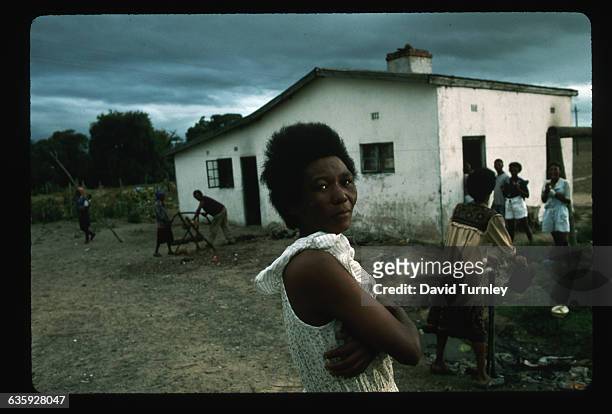 Agricultural workers perform daily chores in front of their living quarters on a wine estate near Stellenbosch. | Location: near Stellenbosch, South...